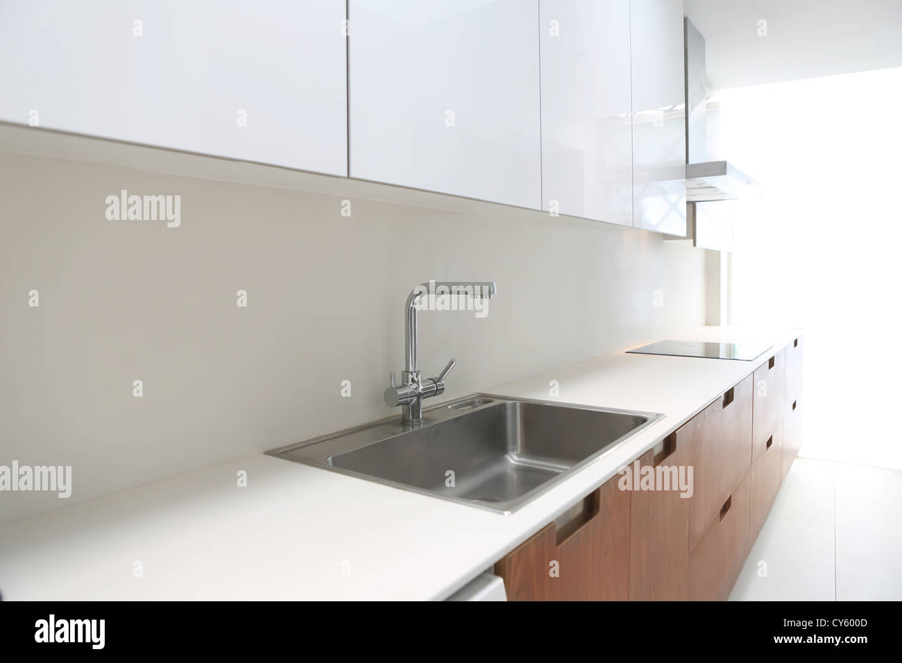 Actual modern kitchen in white and walnut wood interior house Stock Photo