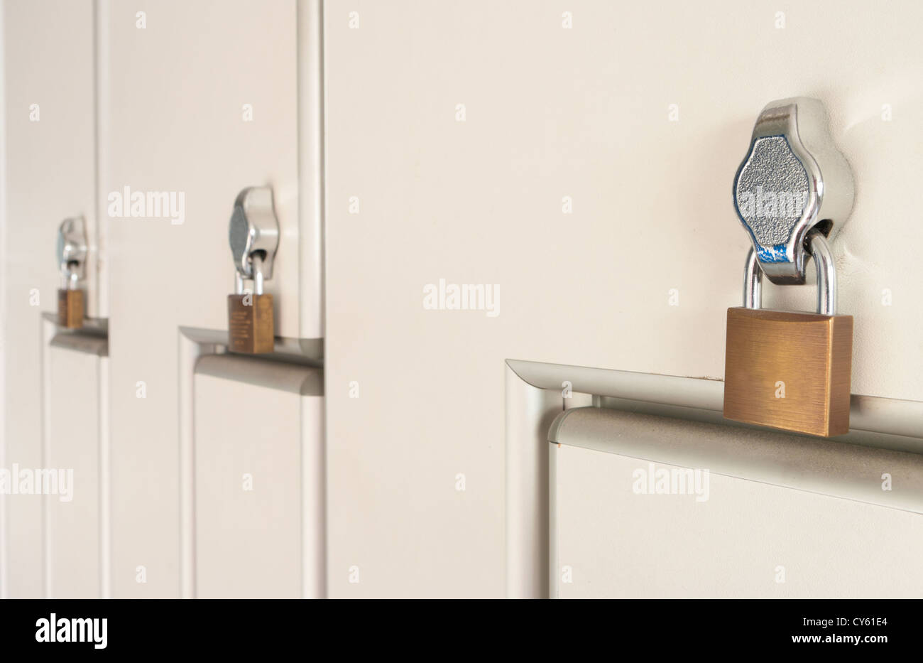 safety locks on white industrial metal lockers Stock Photo Alamy
