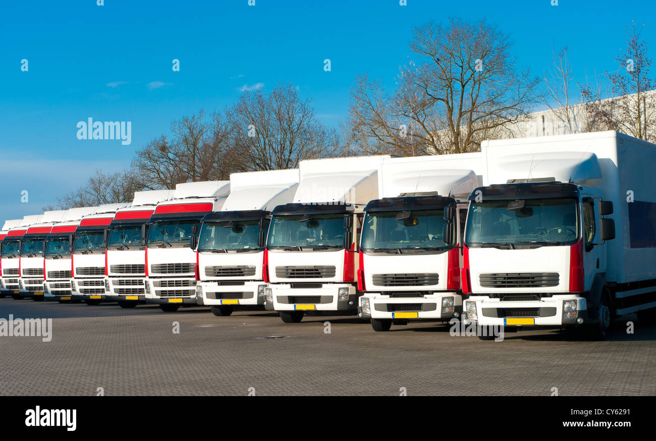 several trucks parked in a perfect row Stock Photo
