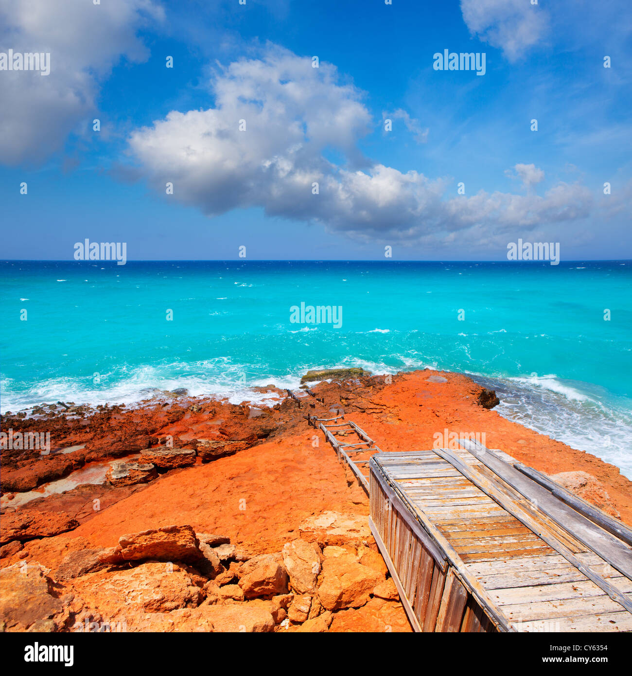 Cala Saona rocky coast with aqua turquoise rough Mediterranean sea Stock Photo