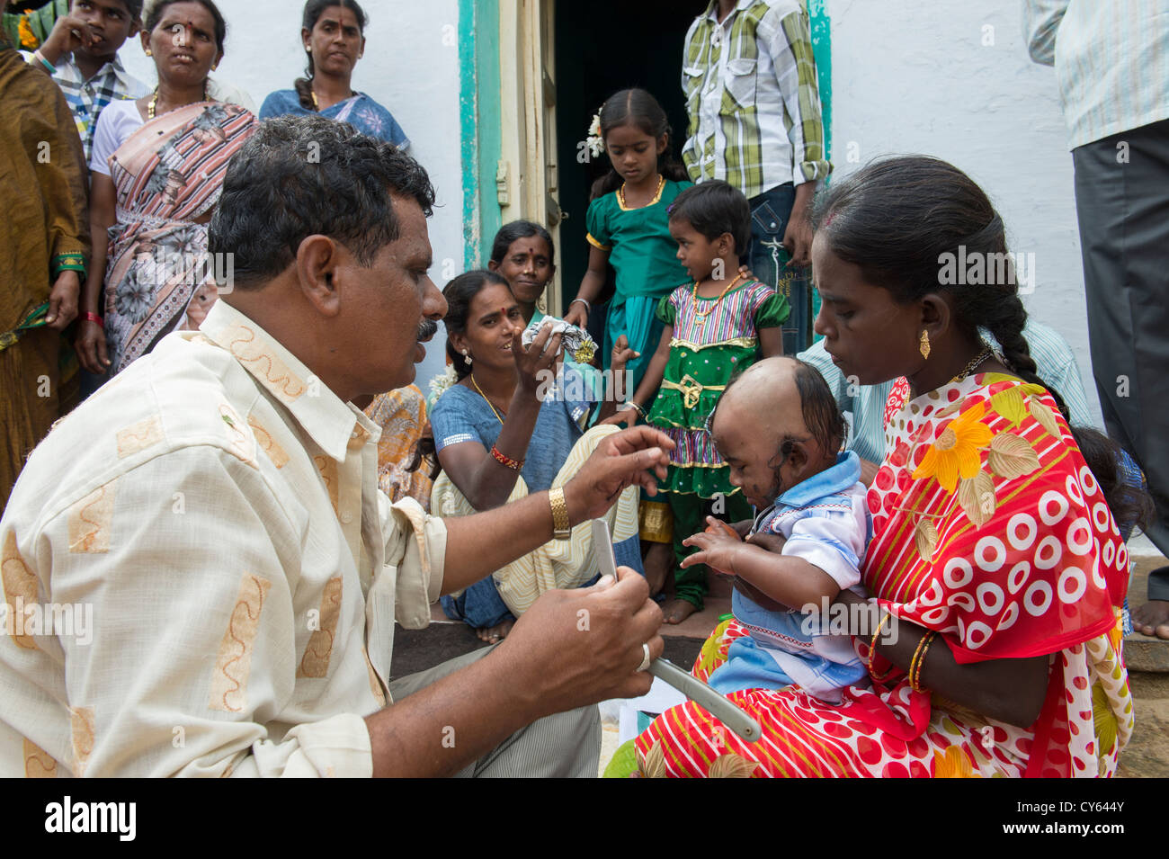 Indian baby hair cutting ritual / puja in a rural indian village. Andhra  Pradesh. India Stock Photo - Alamy