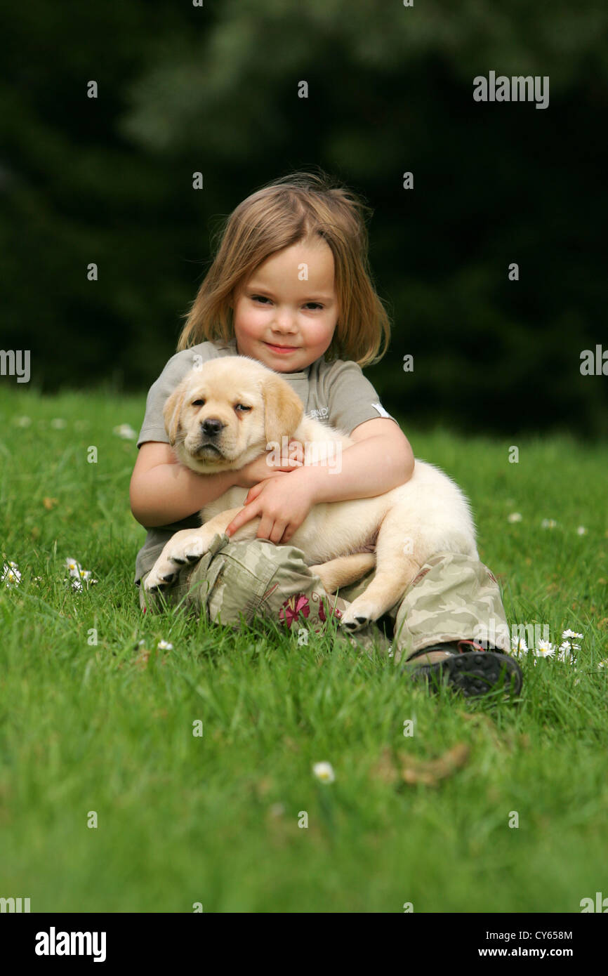 girl with Labrador Retriever puppy Stock Photo Alamy