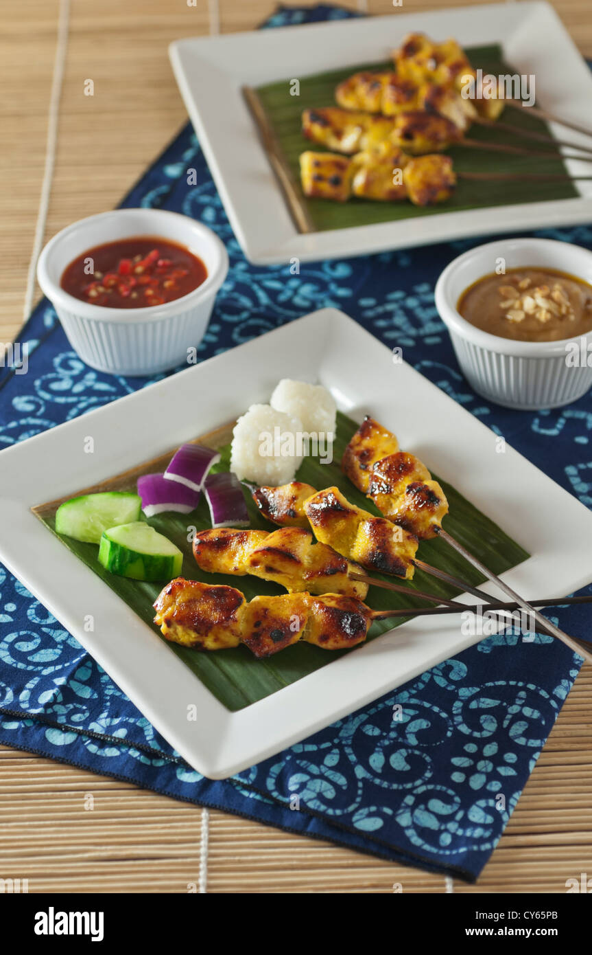 Chicken satay with peanut and chilli sauce Stock Photo