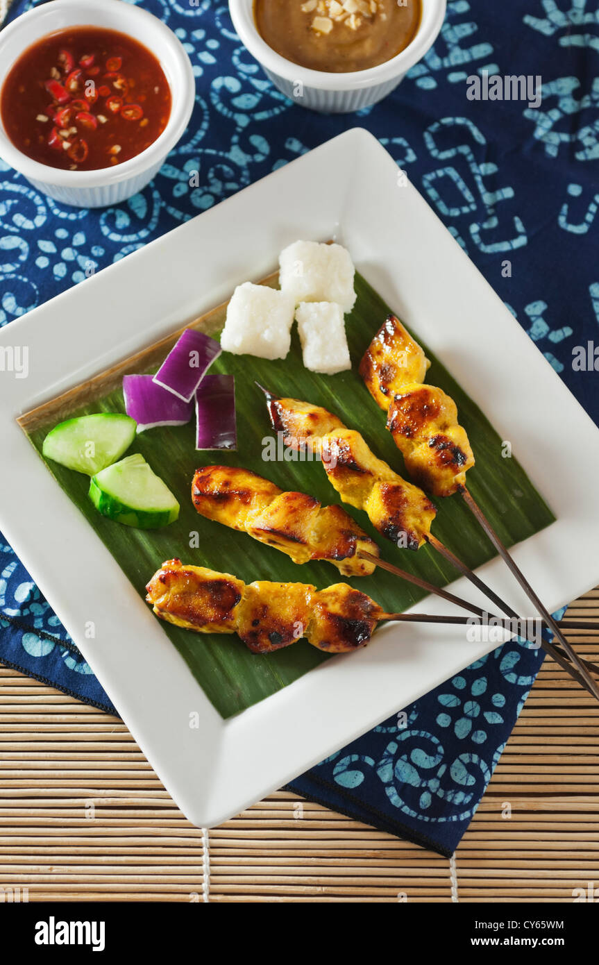 Chicken satay with peanut and chilli sauce Stock Photo