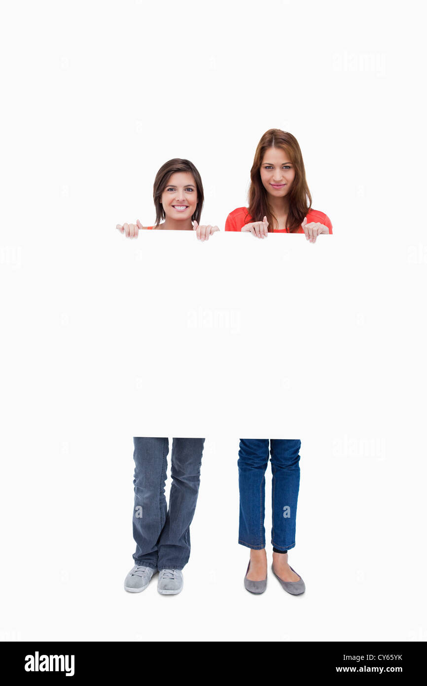 Smiling young women proudly holding a blank poster Stock Photo - Alamy