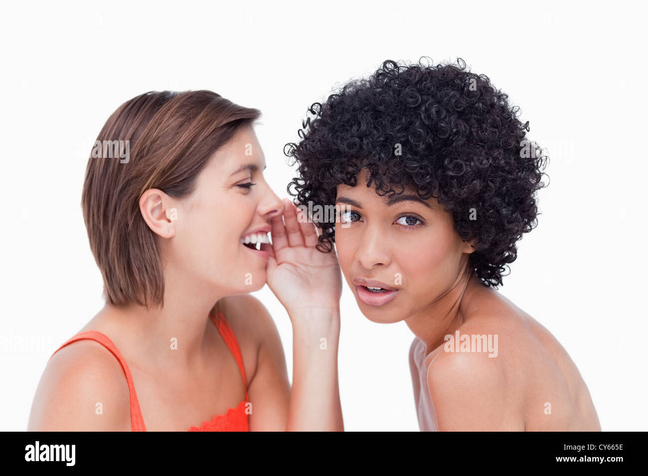 Teenage girl being told a secret by a friend Stock Photo