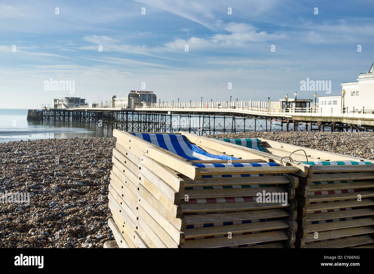 A pile of folded deck chairs with the Art Deco pier in the background. Picture by Julie Edwards Stock Photo