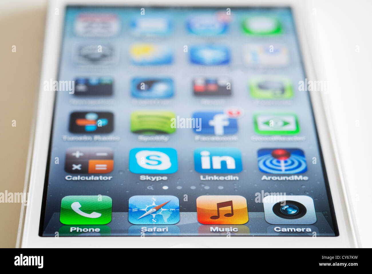 Close-up of new iPhone 5 smart phone showing screen with many apps Stock Photo