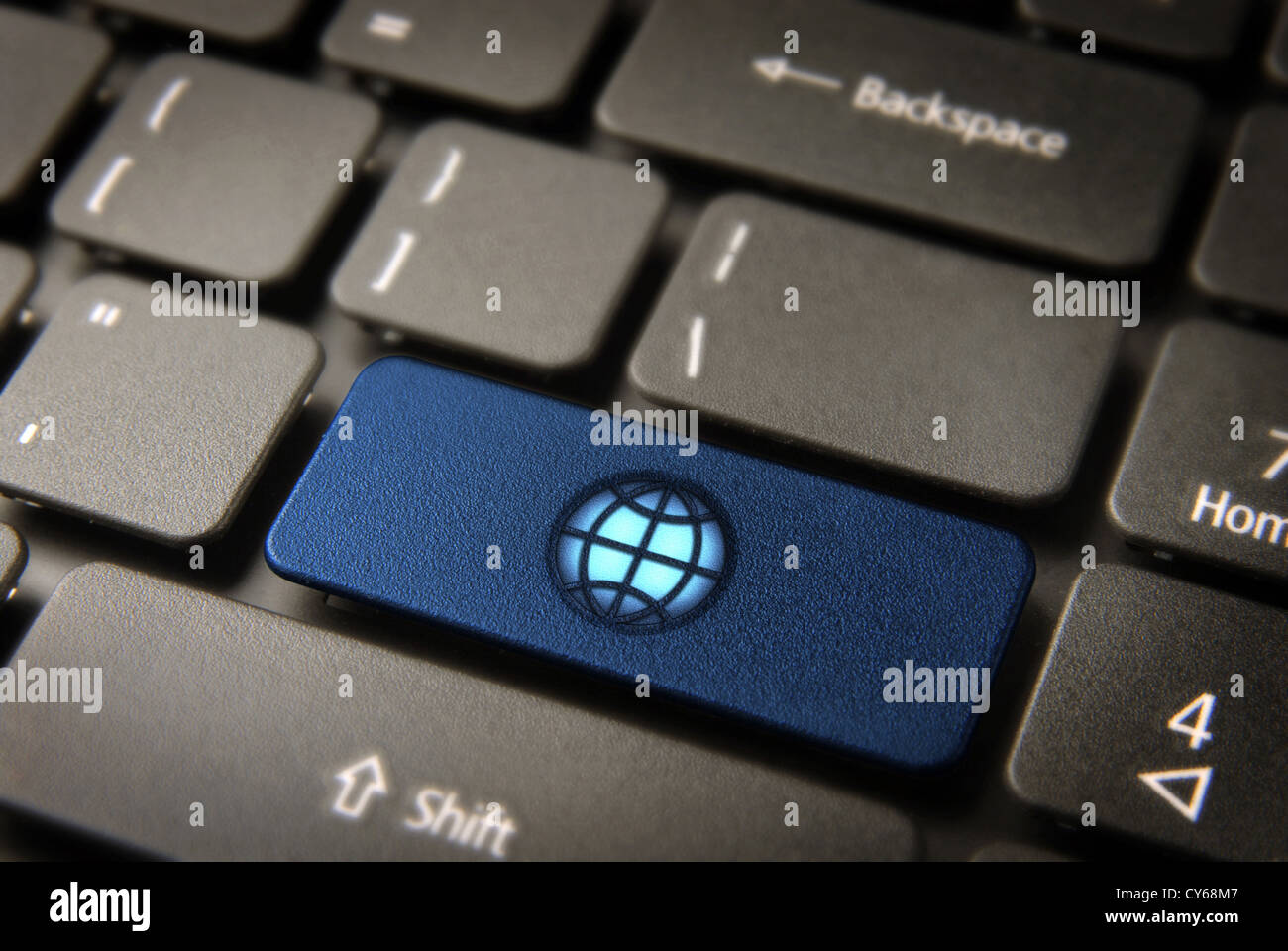 Global internet business key with Globe map icon on laptop keyboard. Included clipping path, so you can easily edit it. Stock Photo