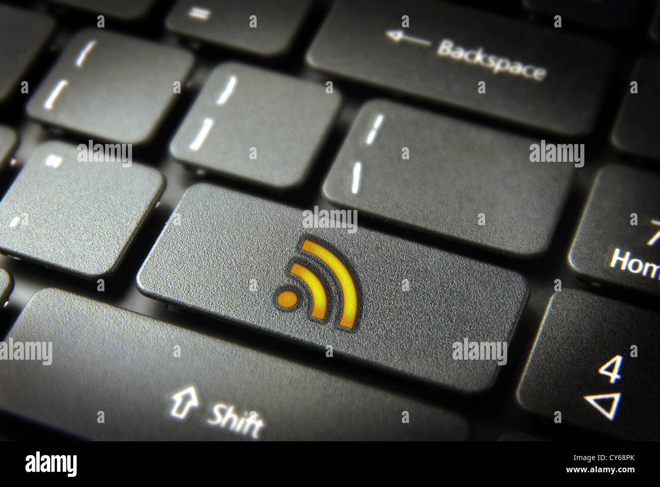 Golden technology RSS icon key on laptop keyboard. Included clipping path, so you can easily edit it. Stock Photo