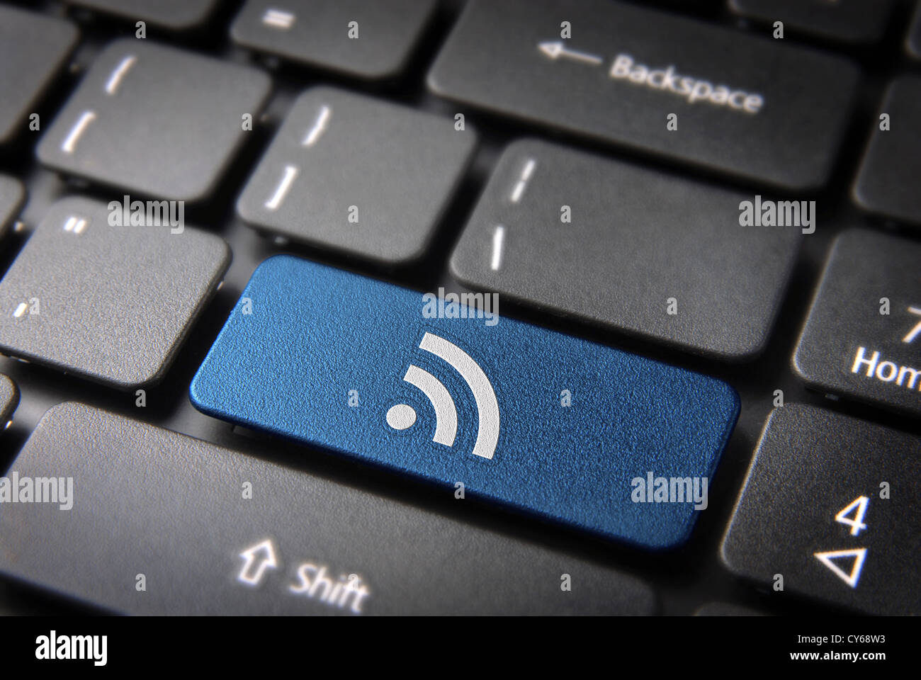 Blue technology key with RSS icon on laptop keyboard. Included clipping path, so you can easily edit it. Stock Photo