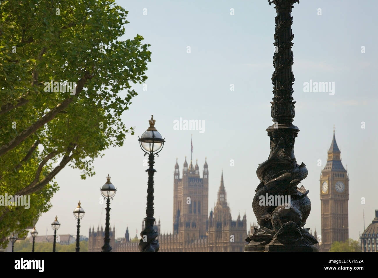 A line of ornate street lamps framing a view of Big Ben and the Houses of Parliament, London, UK. Stock Photo