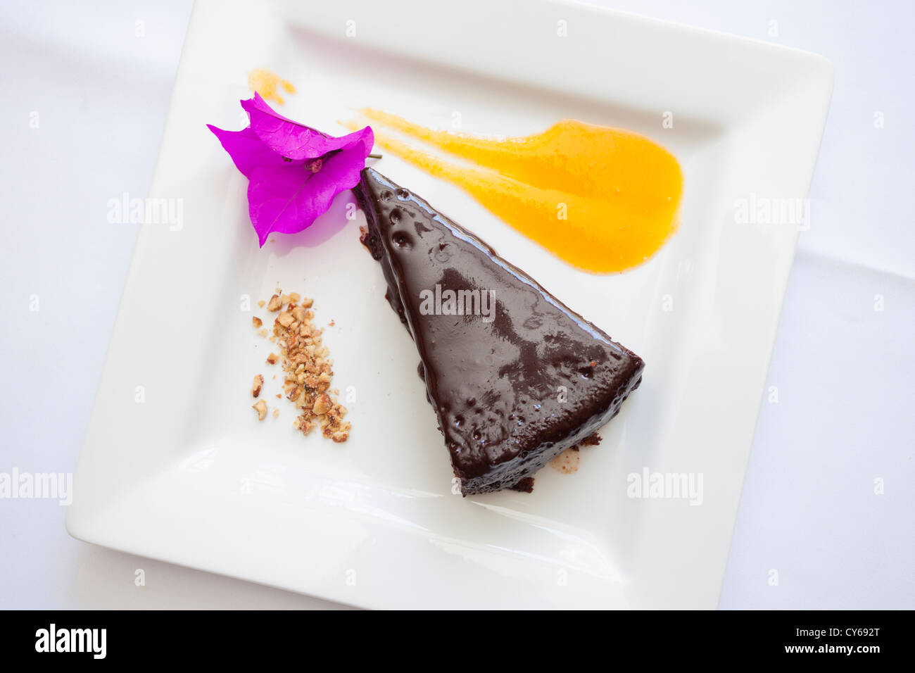 Chocolate cake with passion fruit sauce prepared by Chef Pilar Cabrera at La Olla restaurant in Oaxaca, Mexico Stock Photo