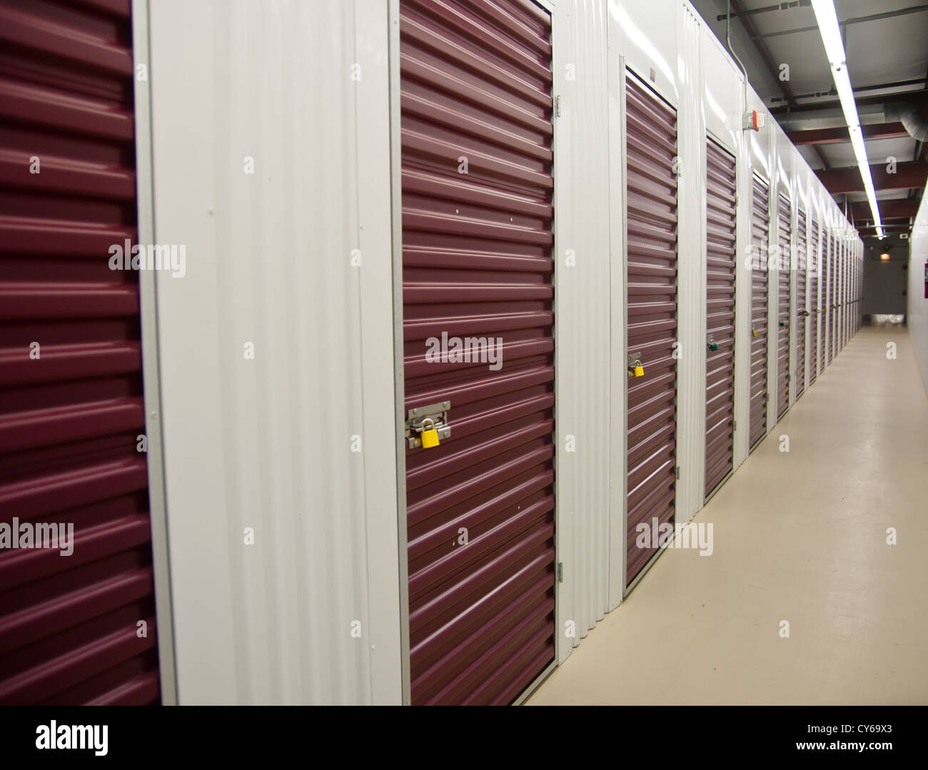 Interior storage units; purple storage unit doors and hallway Stock