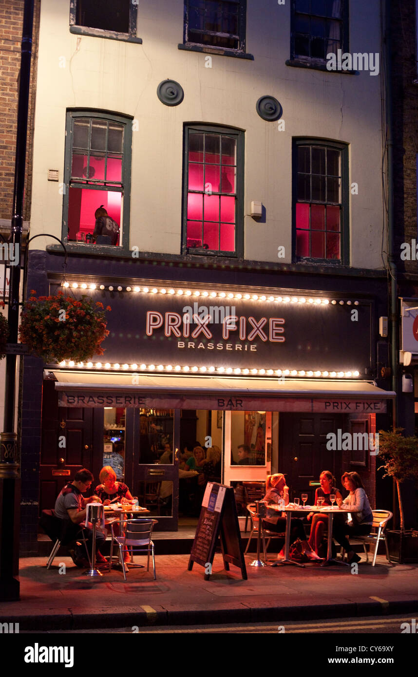 Customers dining al fresco at the Prix Fixe brasserie, Soho, London, England, UK. Stock Photo
