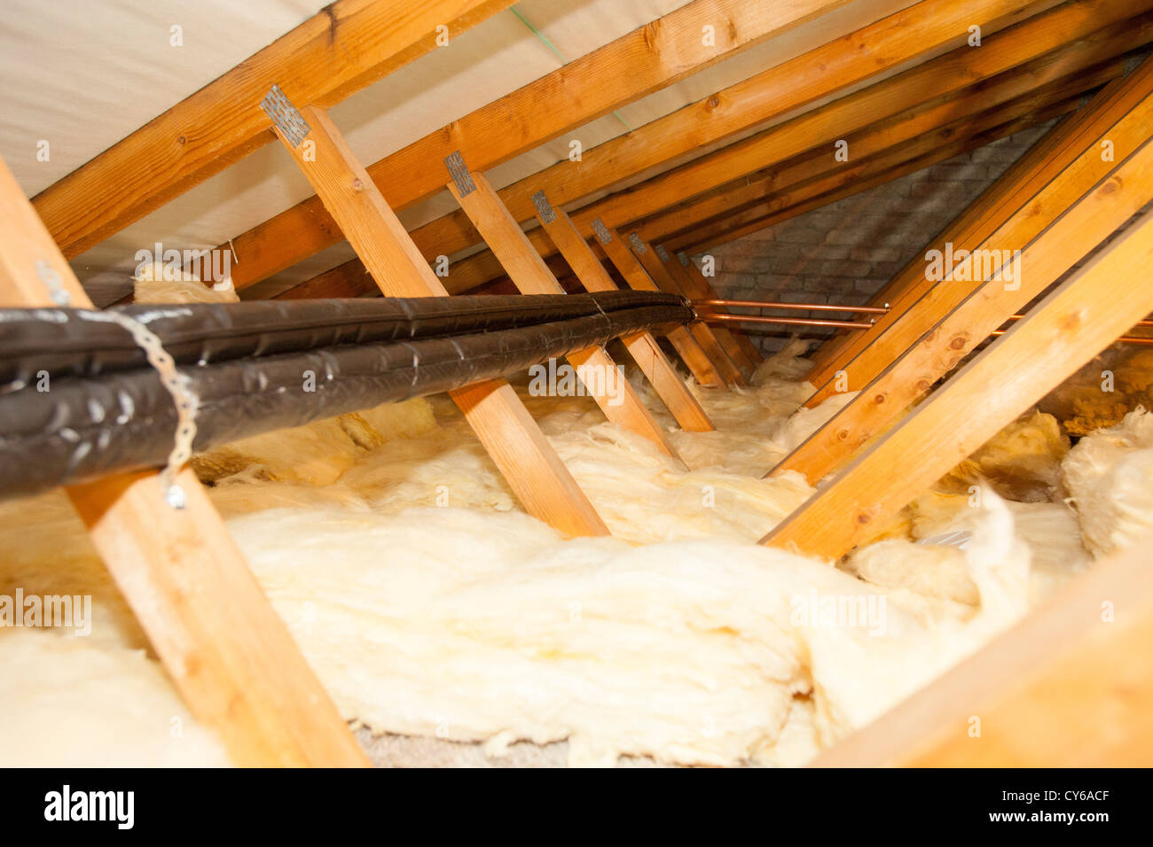 Pipes being run through a loft space to connect to a solar thermal