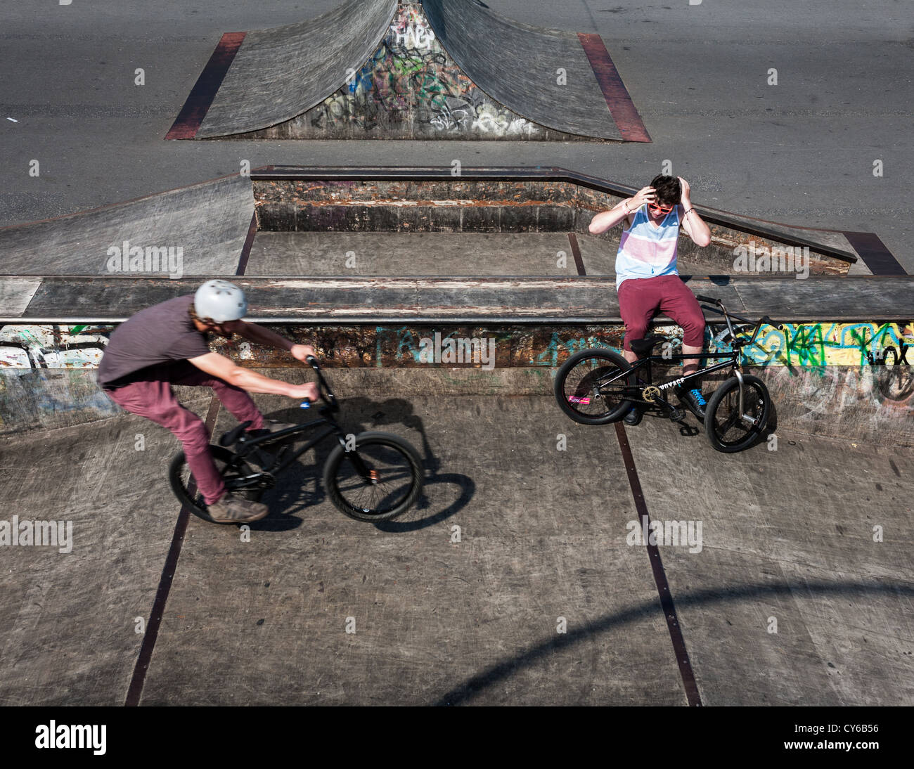 Teenagers riding bikes in a skate park Stock Photo Alamy