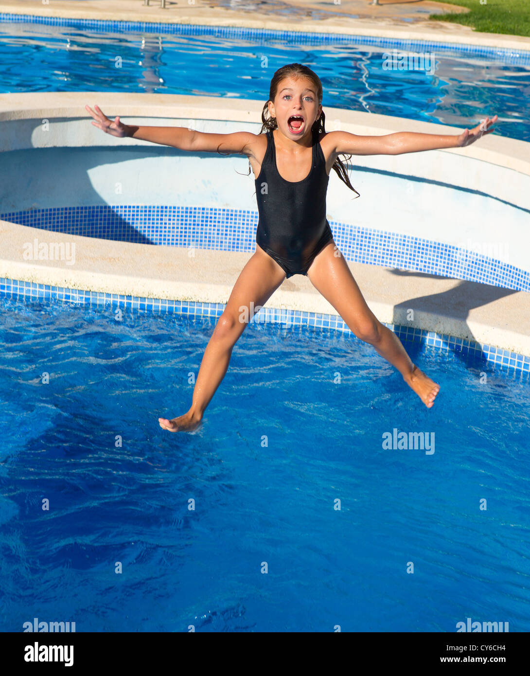 children girl jumping to the blue pool with black swimsuit in summer vacations Stock Photo Alamy