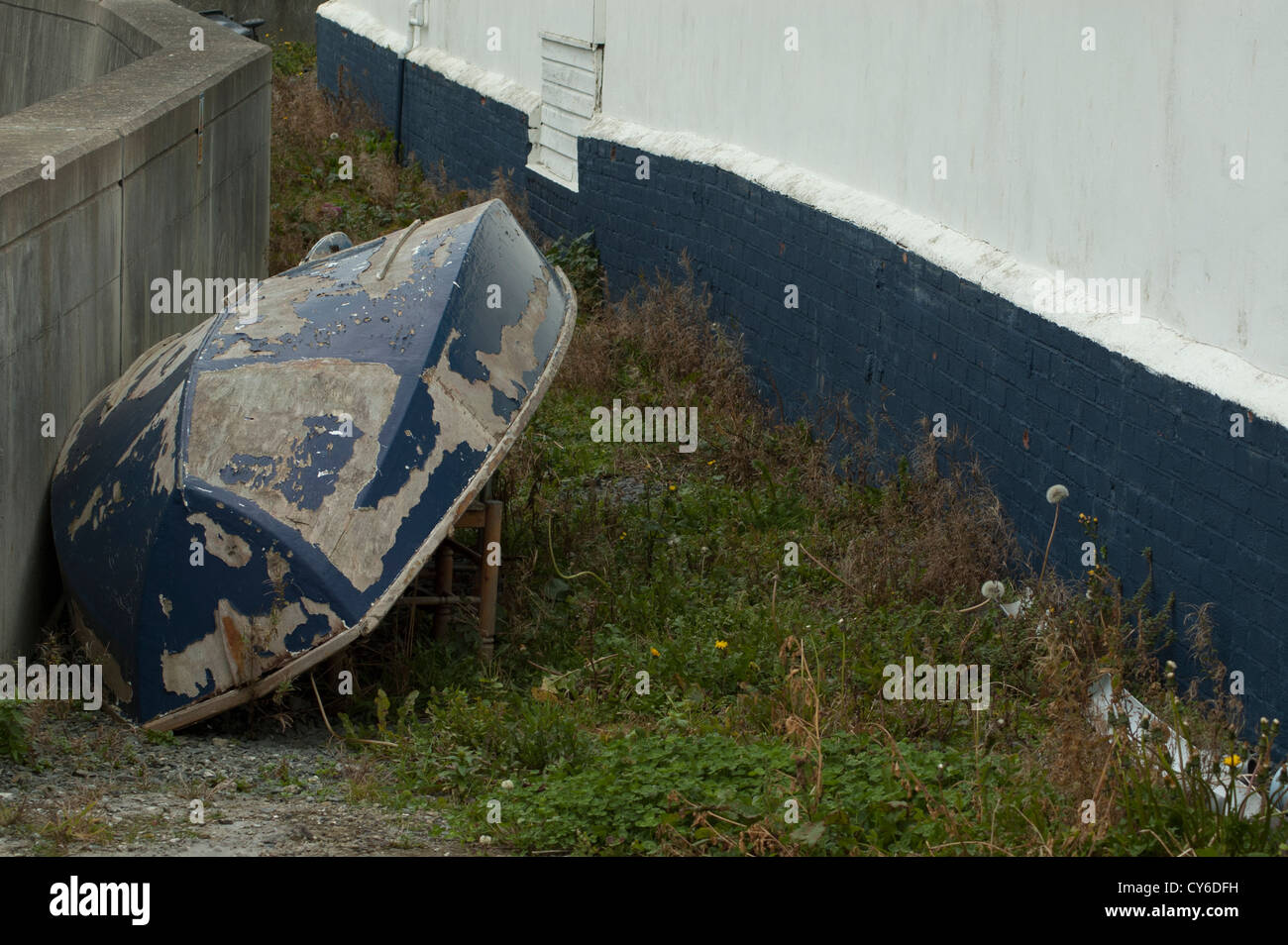 Upturned boat in need of repair. Stock Photo