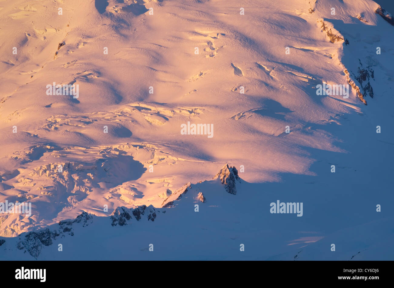 Glaciers on the flanks of Mount Baker glowing in the winter dawn. Stock Photo