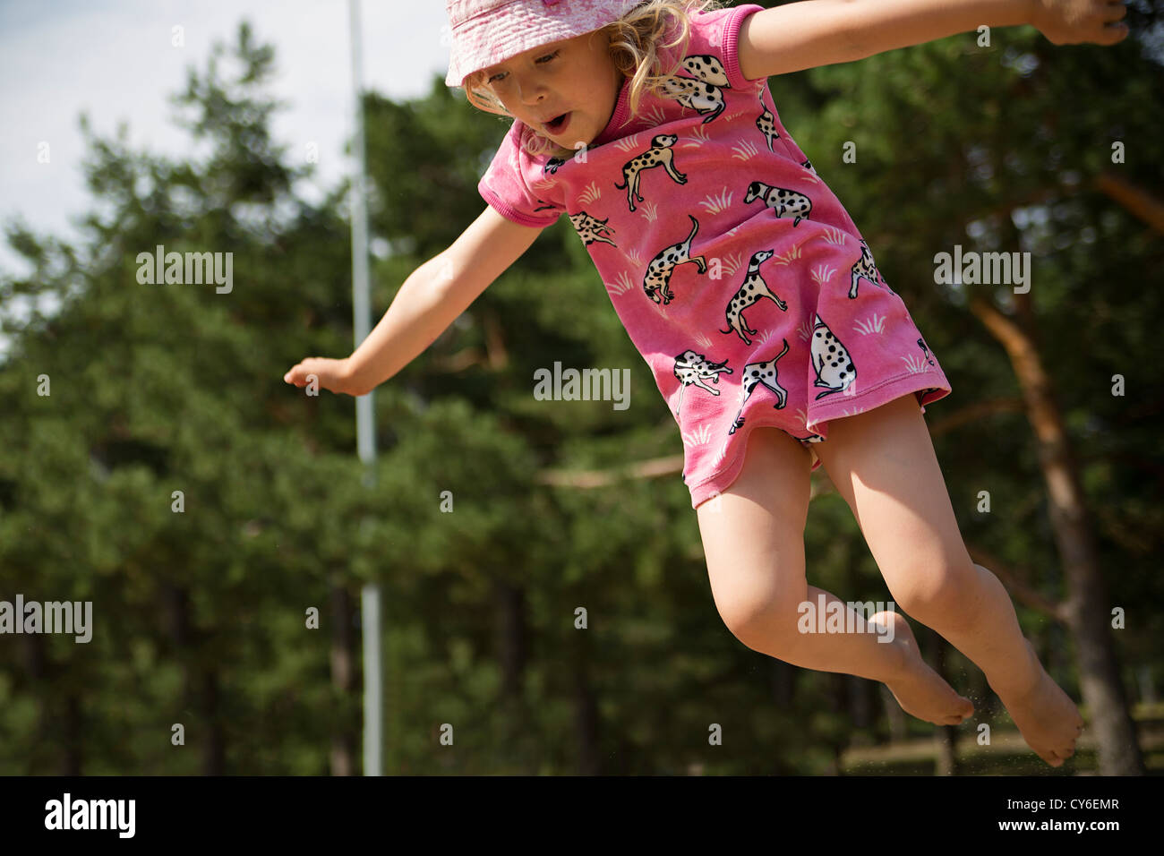 Cute girl is captured on camera while jumping Stock Photo