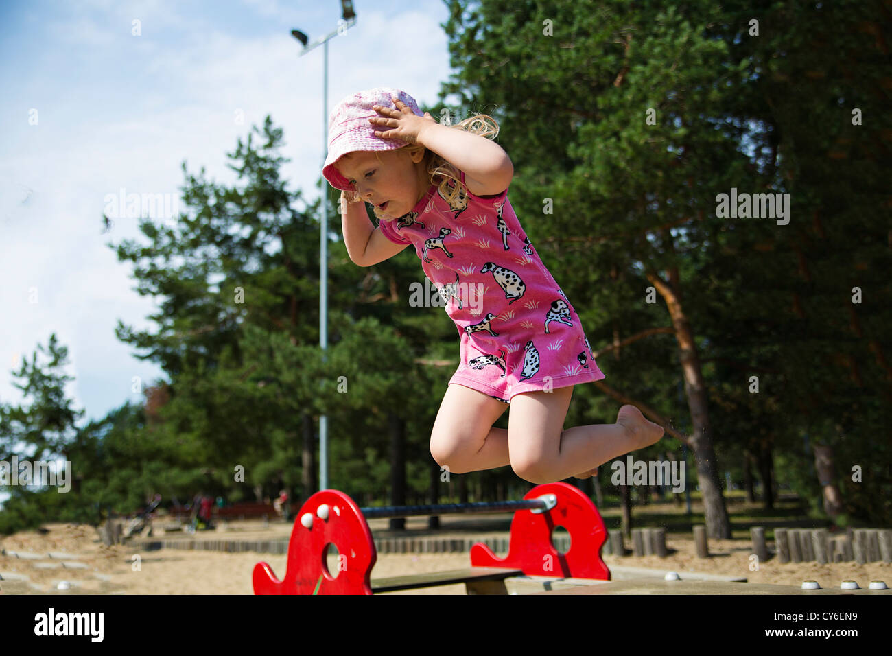 Girl captured on camera while jumping on trampoline Stock Photo