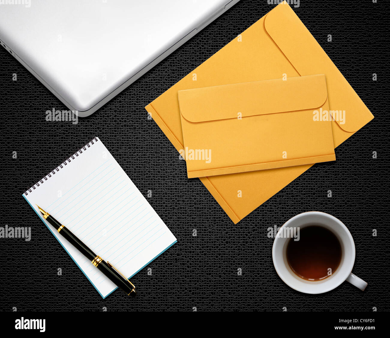 business desktop with laptop, notepad, envelops and coffee Stock Photo
