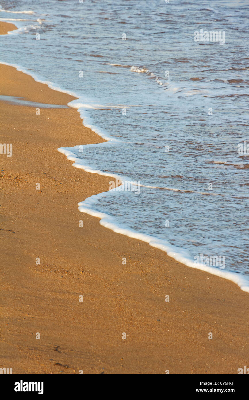 Foamy sea shore at the beach in the afternoon in Greece Stock Photo
