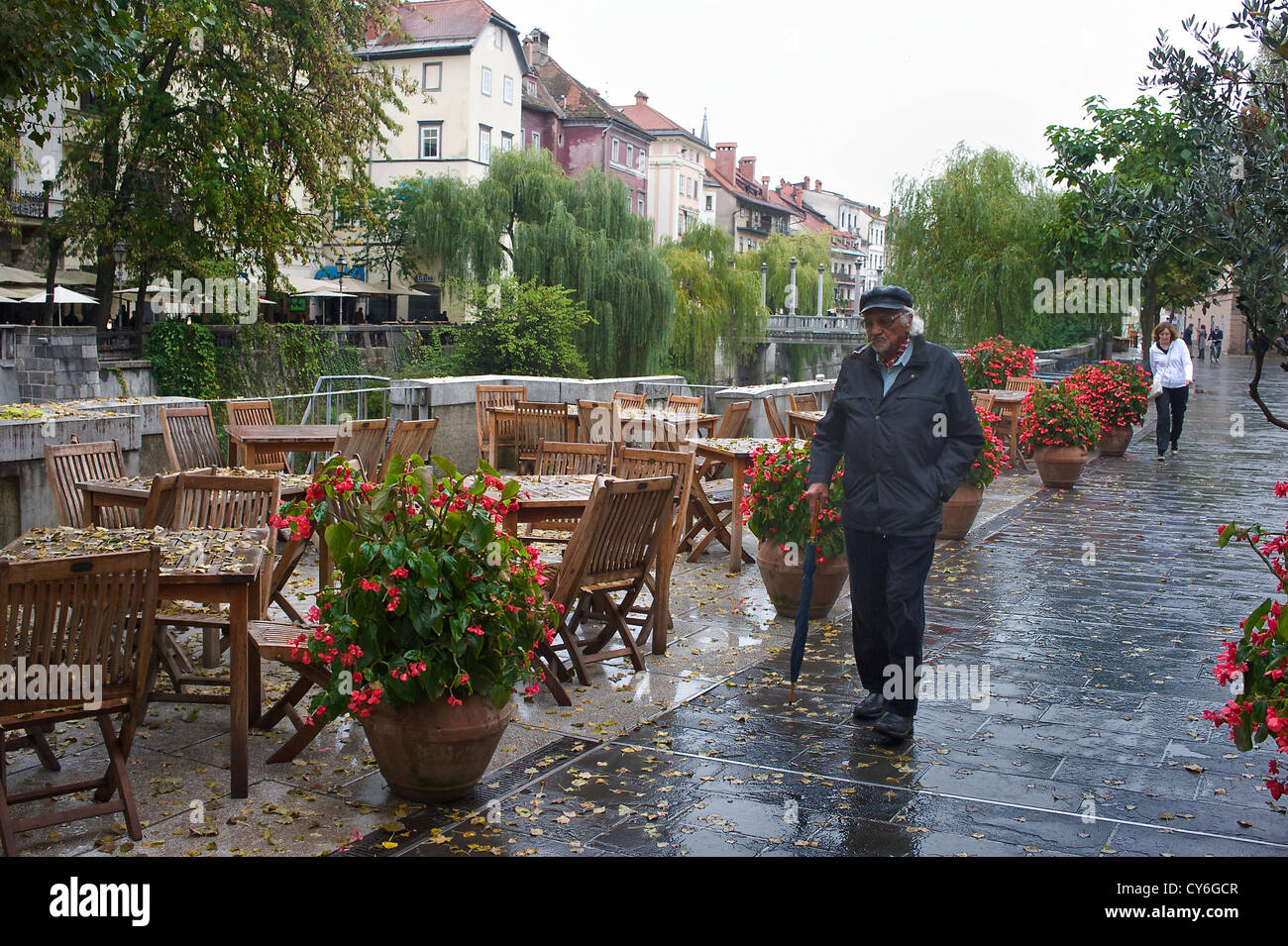 Slovenian man walking on riverwalk in downtown Ljubljana Stock Photo