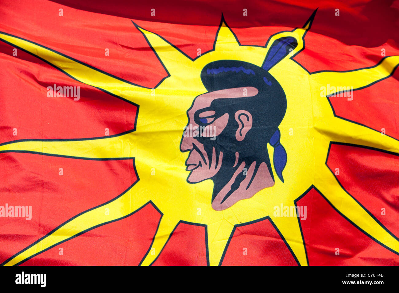 A First Nation Canadian protests with a native flag against the