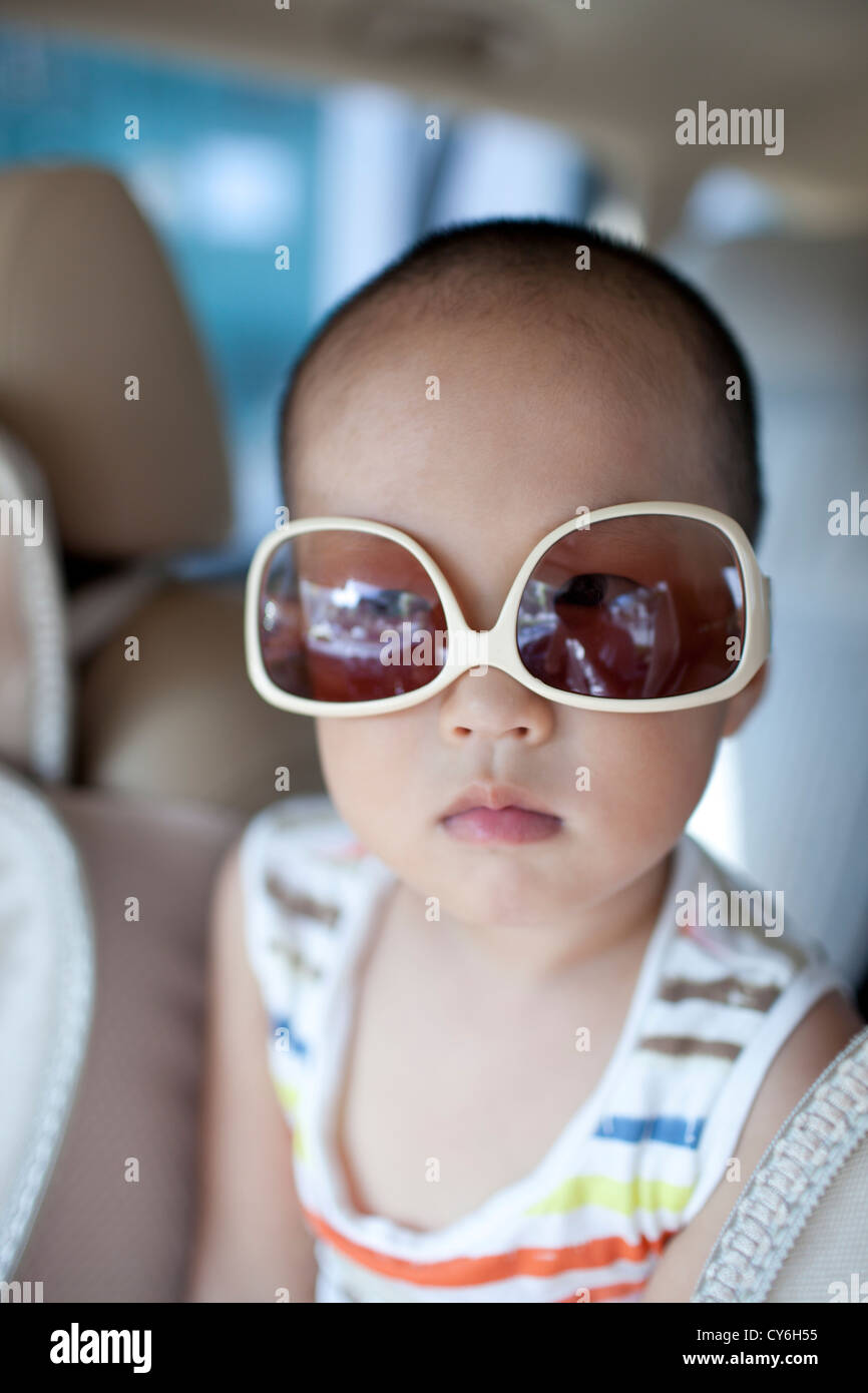 Asian boy wearing sunglass in the car with cute Stock Photo Alamy