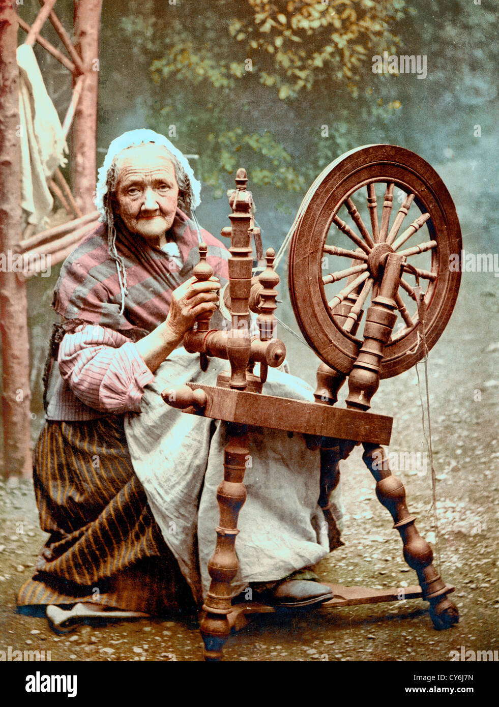 Irish spinner and spinning wheel. County Galway, Ireland, circa 1900