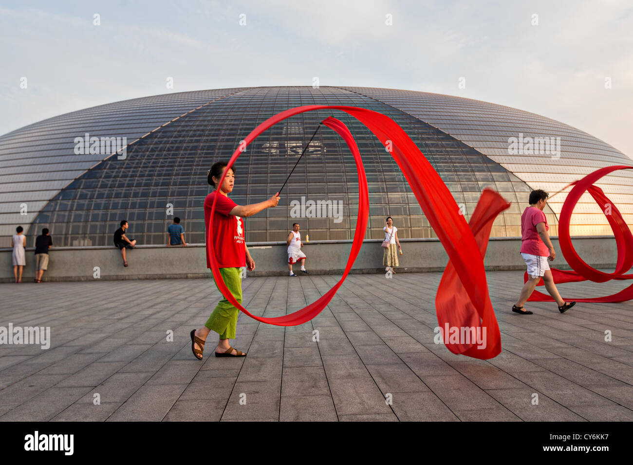 Women practice ribbon dancing at the National Centre for Performing Arts park in Beijing, China