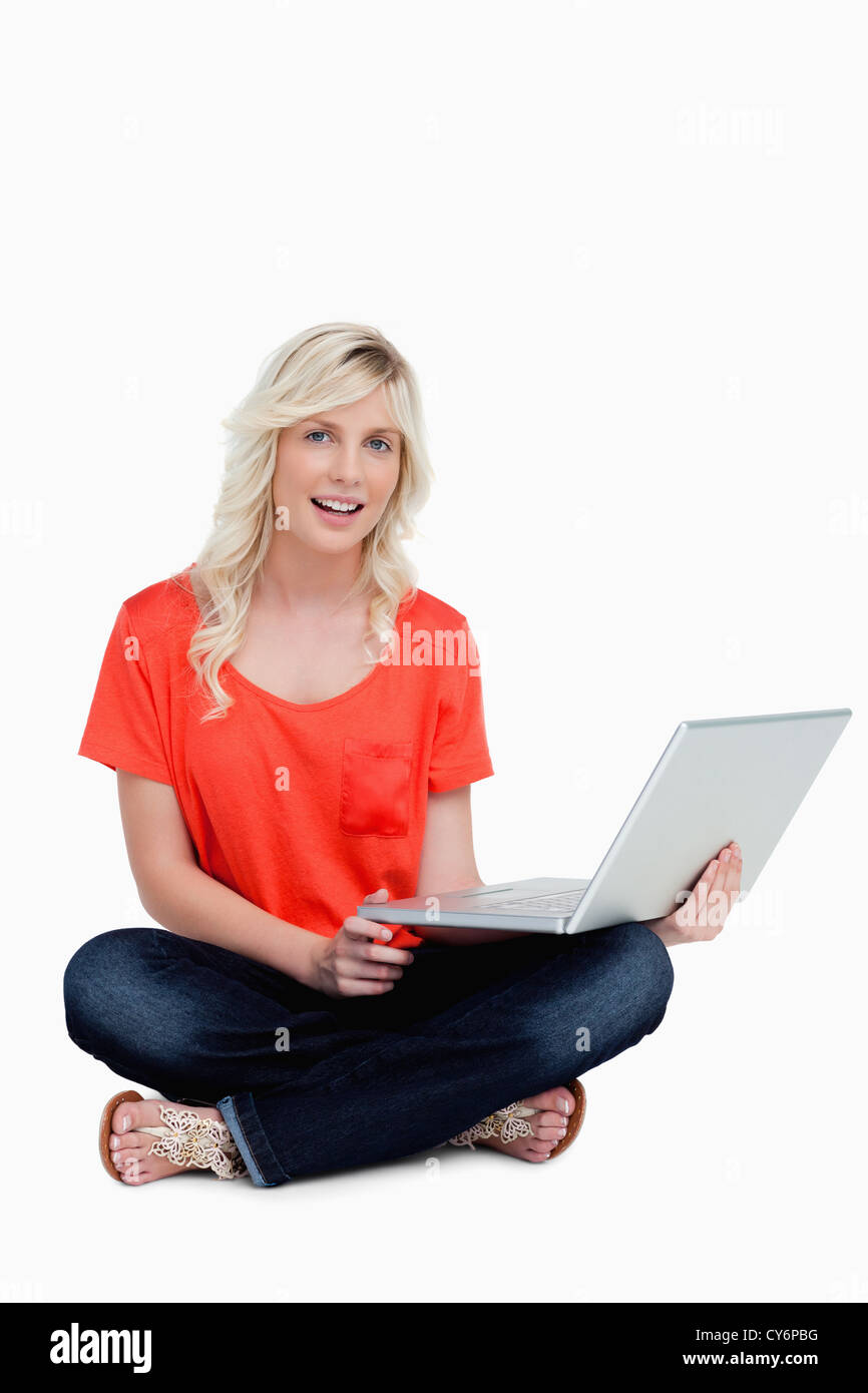 Young woman sitting crosslegged holding her laptop Stock Photo Alamy