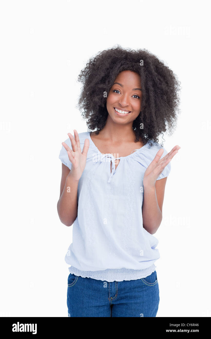 Young woman raising her hands as an indication of happiness Stock Photo