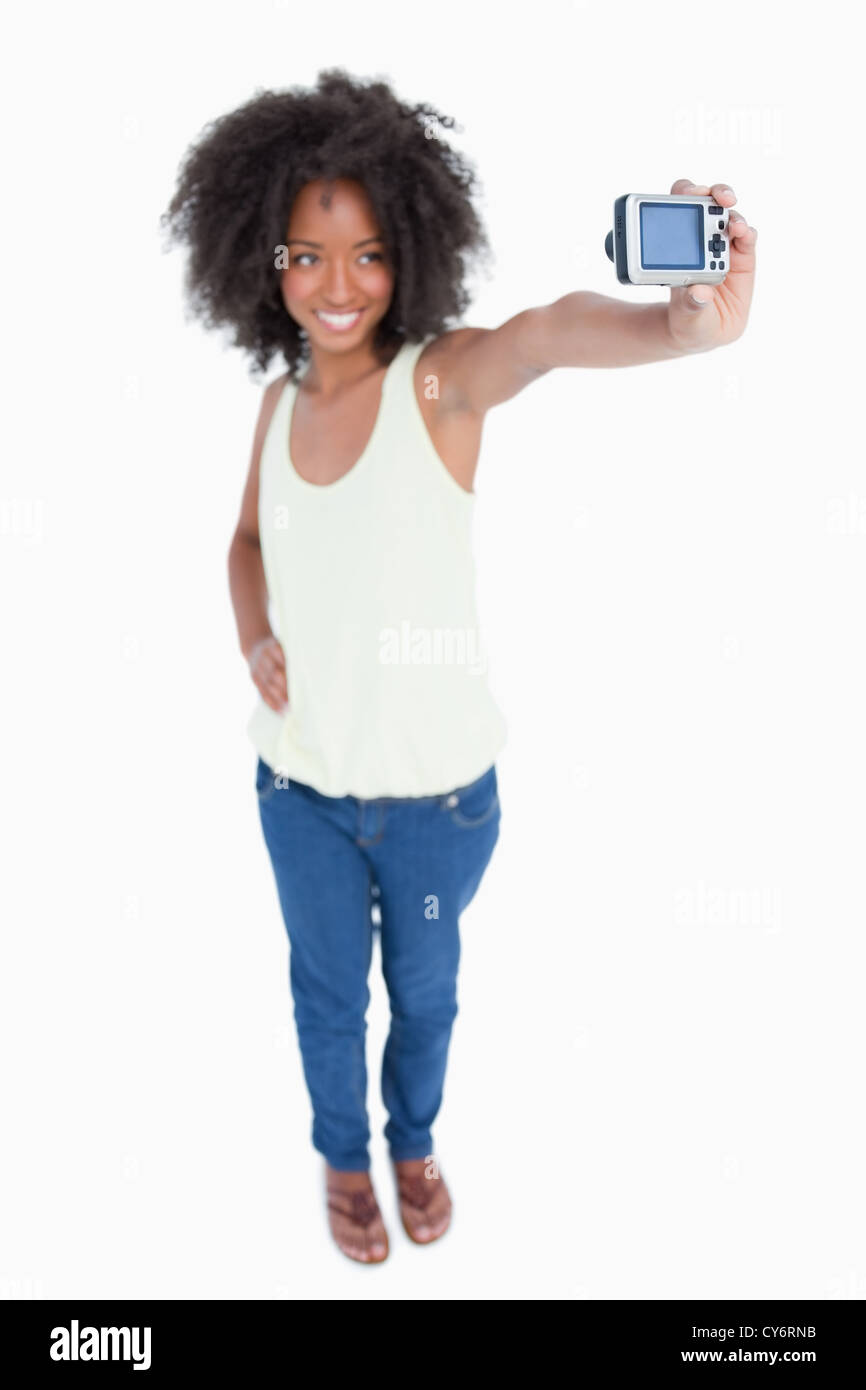 Young smiling woman holding her digital camera Stock Photo - Alamy