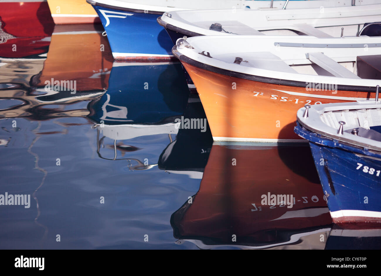 Reflections of some boats moored in the port of San Sebastian in the Basque Country. Stock Photo