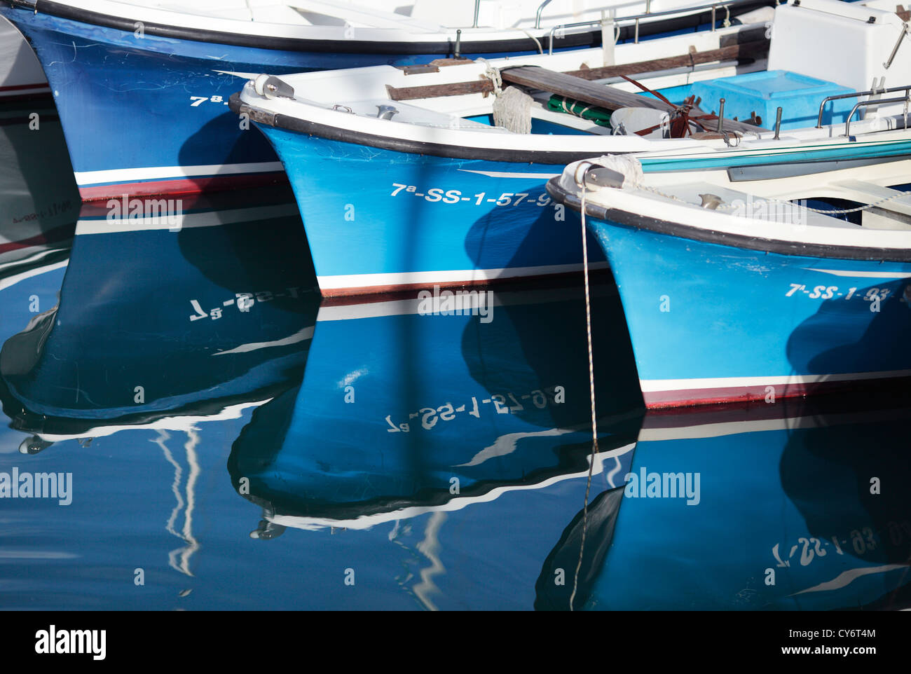 Reflections of some boats moored in the port of San Sebastian in the Basque Country. Stock Photo