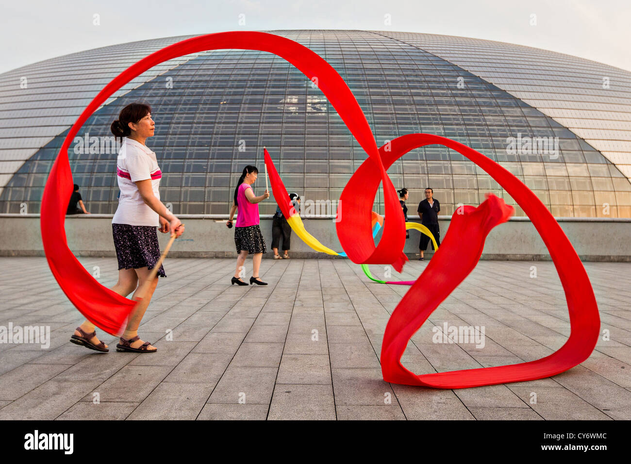 Women practice ribbon dancing at the National Centre for Performing Arts park in Beijing, China