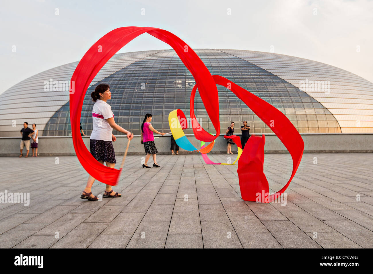 Women practice ribbon dancing at the National Centre for Performing Arts park in Beijing, China