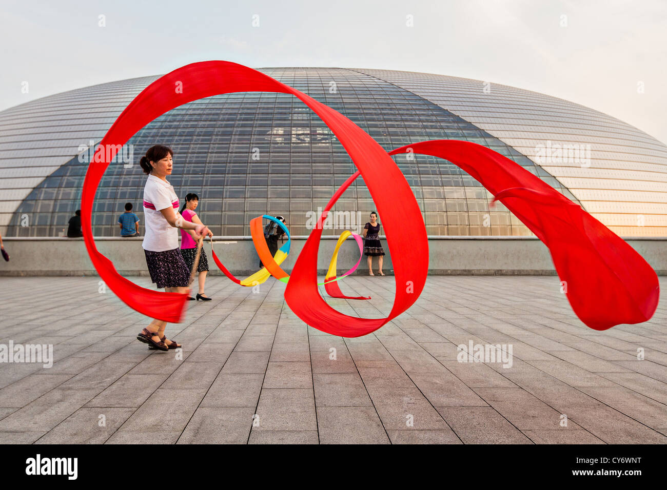 Women practice ribbon dancing at the National Centre for Performing Arts park in Beijing, China
