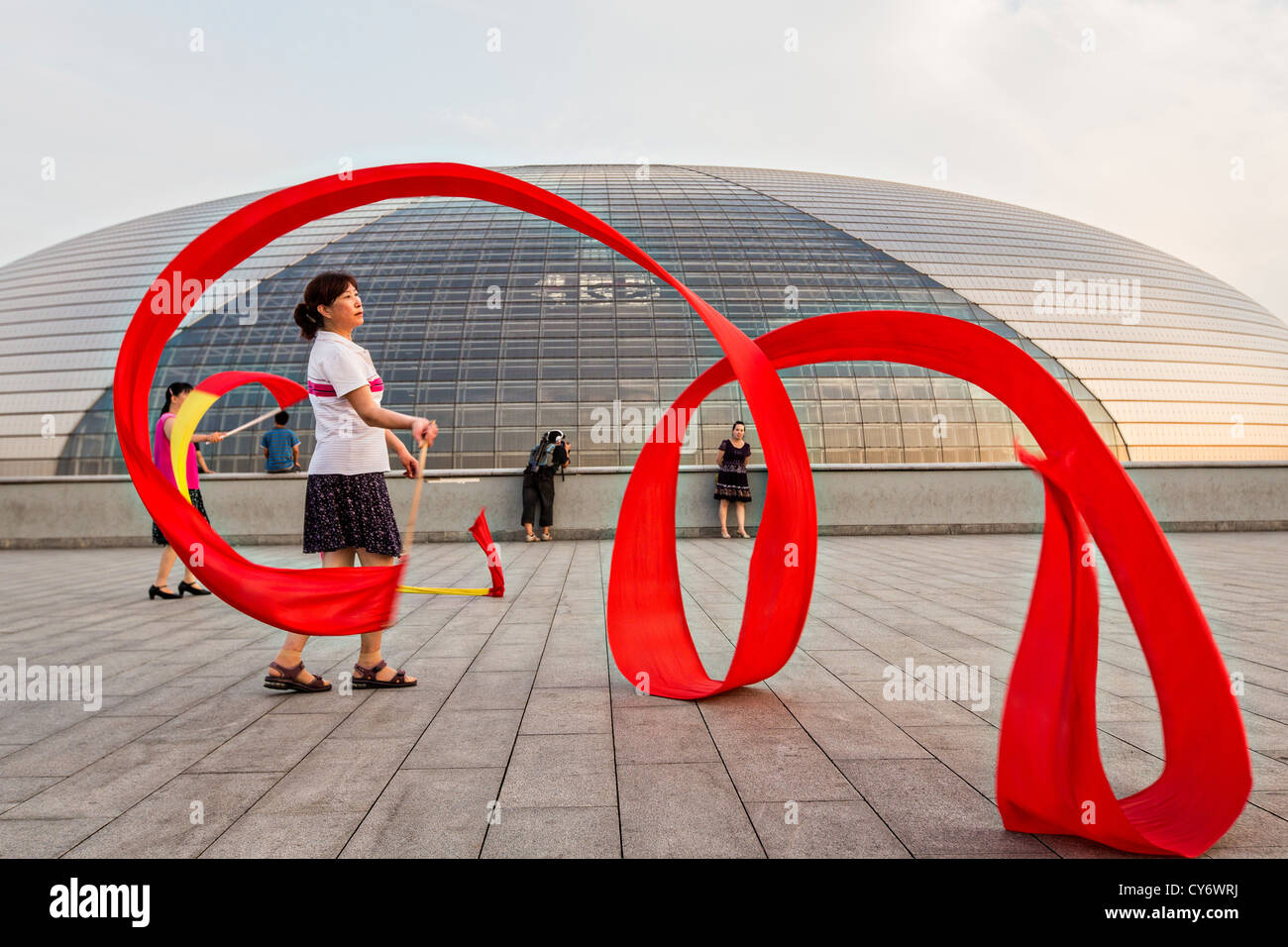Women practice ribbon dancing at the National Centre for Performing Arts park in Beijing, China