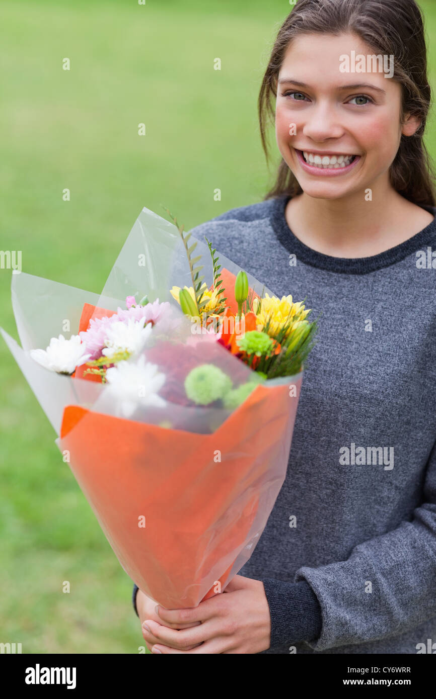 Young girl holding a bunch of flowers Stock Photo - Alamy