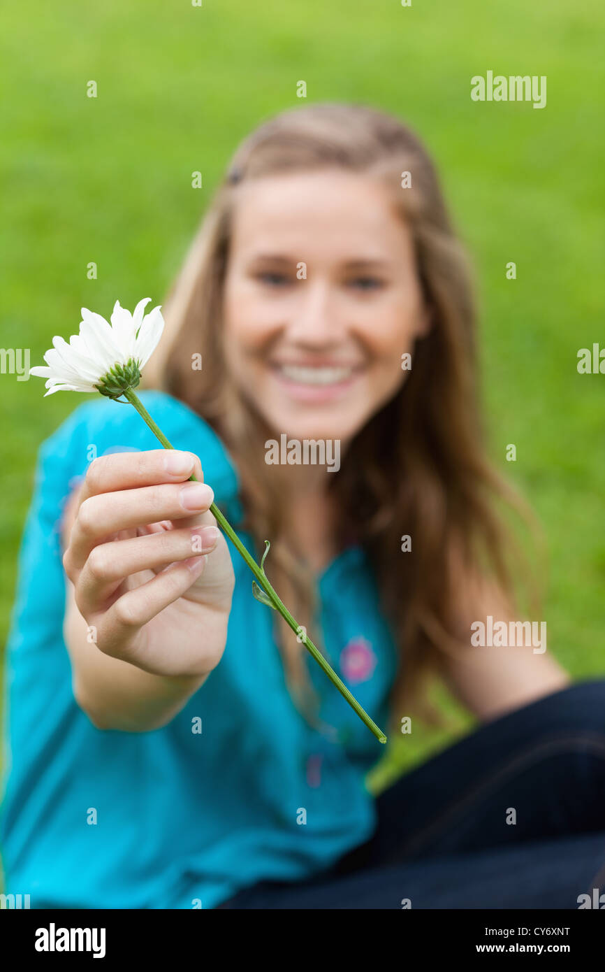 White flower held by a young smiling woman Stock Photo - Alamy