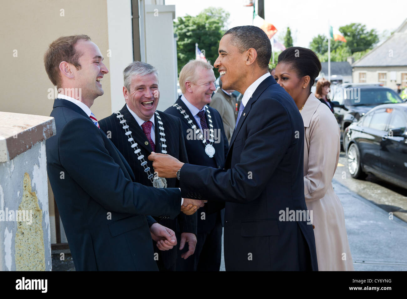 US President Barack Obama and First Lady Michelle Obama greet Henry Healy, the PresidentÕs distant cousin May 23, 2011 after arriving in Moneygall, Ireland. The President and First Lady were also welcomed by Counselor Danny Owens, Chair Offaly County, and Counselor John Kennedy, Chair Tipperary County. Stock Photo