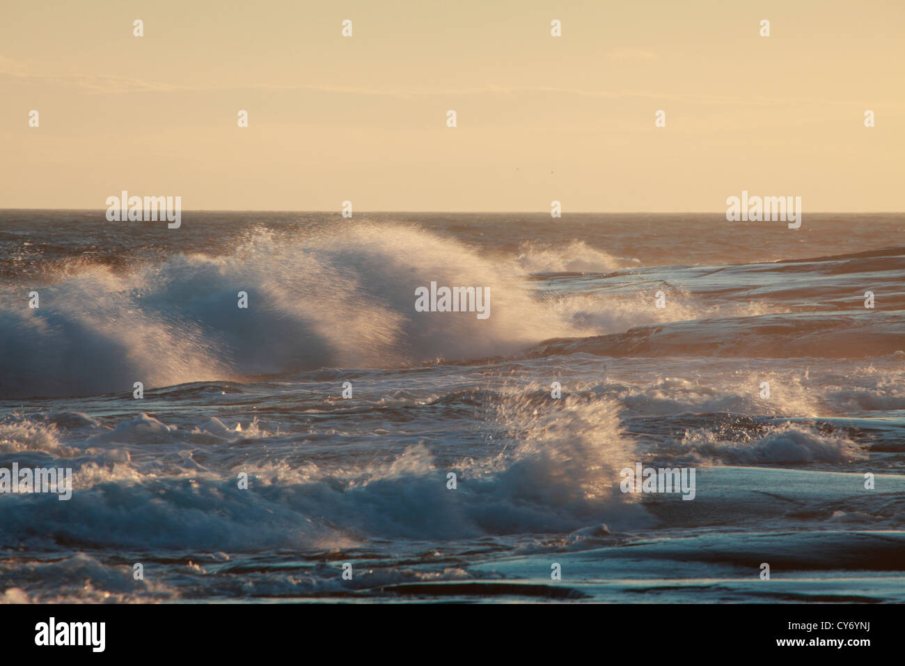 Storm-driven waves are crashing against the rocky coast of the Baltic Sea in Sweden. Stock Photo