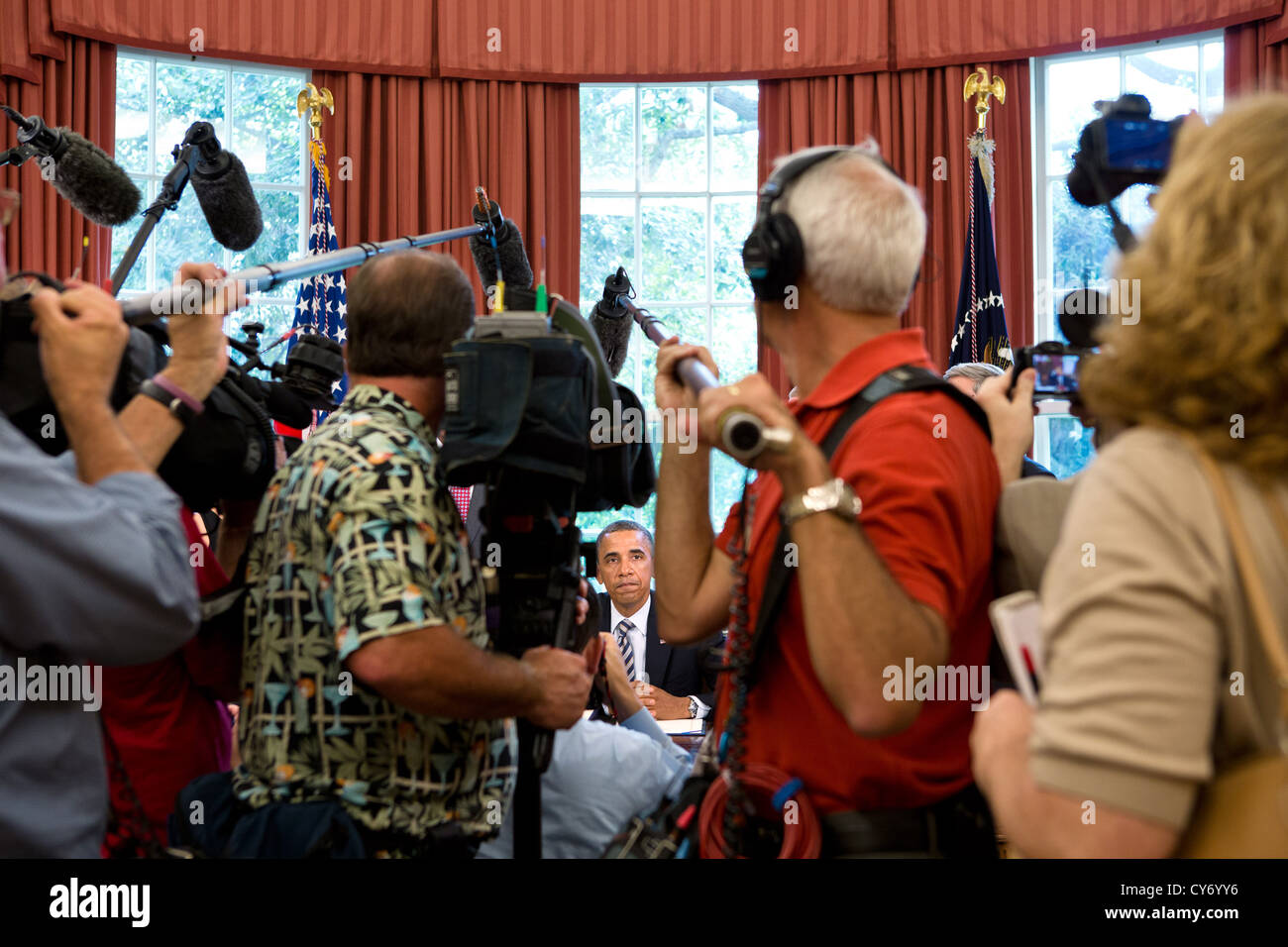 Members of the press document President Barack Obama during the Honoring America's Veterans and Caring for Camp Lejeune Families Act of 2012 signing ceremony August 6, 2012 in the Oval Office of the White House. Stock Photo