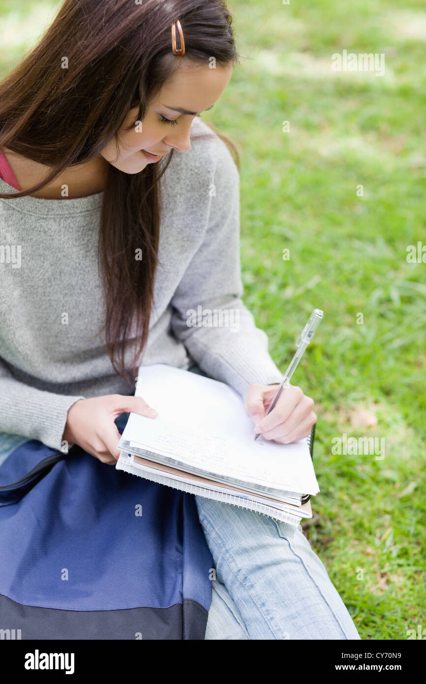 Overhead view of a young girl sitting in a park with her school books Stock Photo