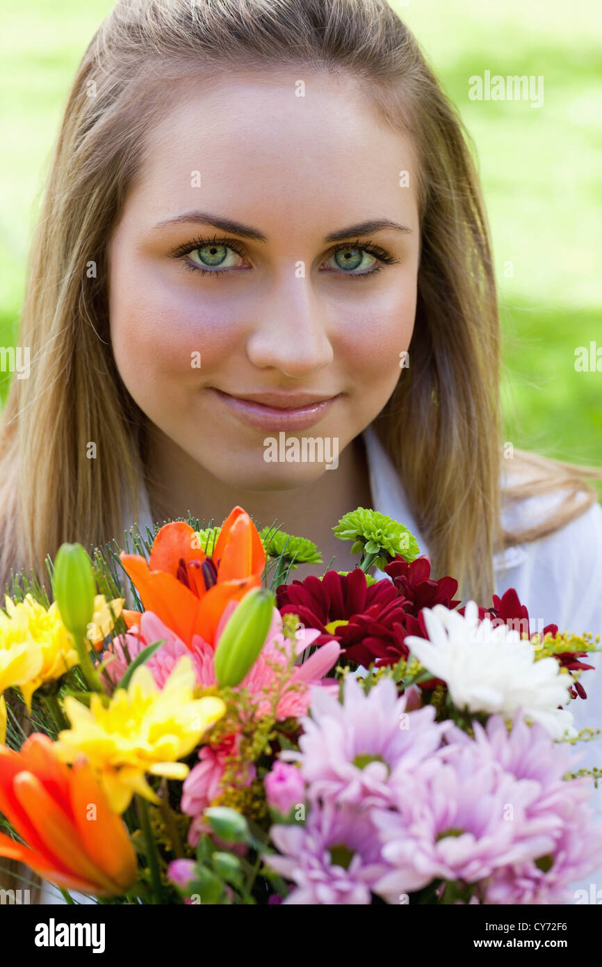 Young relaxed girl holding a bunch of flowers Stock Photo - Alamy