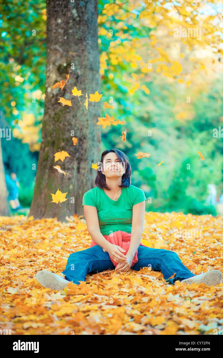 Nice girl playing with autumn falling leaves in the park Stock Photo ...